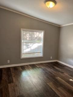 empty room featuring dark wood-type flooring and crown molding