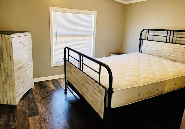 bedroom with dark wood-type flooring and ornamental molding