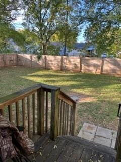 wooden deck with a lawn