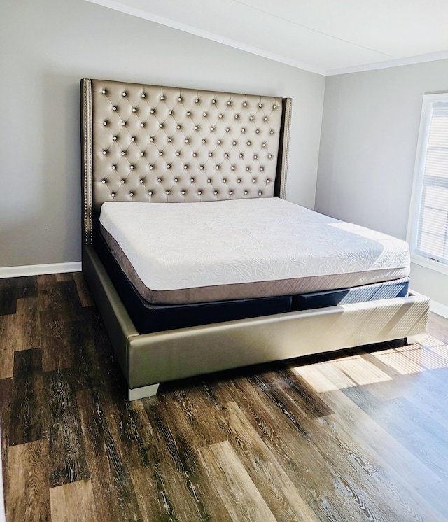 bedroom with dark wood-type flooring and ornamental molding