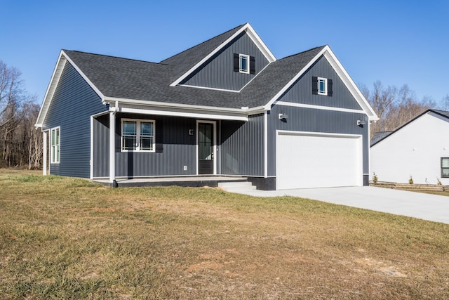 view of front of home with a garage, covered porch, and a front lawn