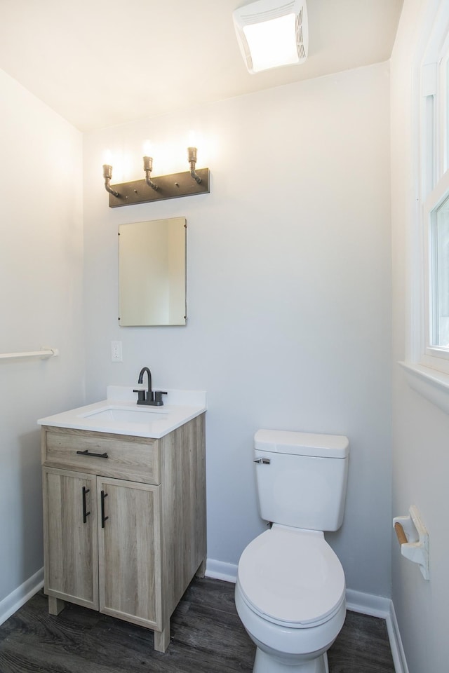 bathroom with vanity, hardwood / wood-style floors, and toilet