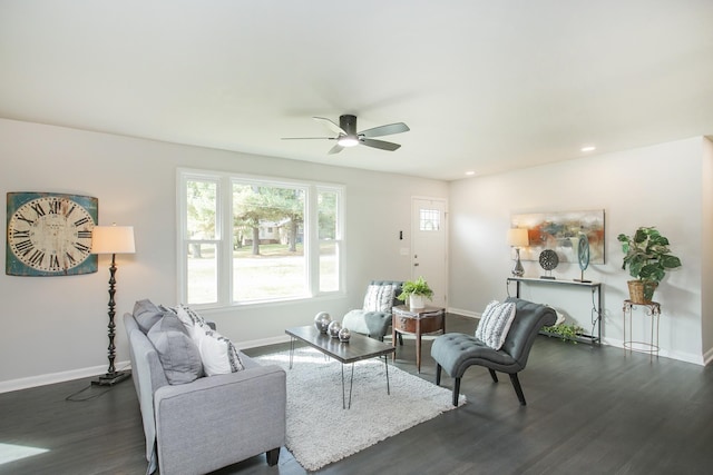 living room with dark hardwood / wood-style flooring and ceiling fan