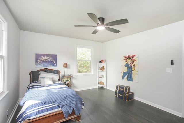 bedroom with dark hardwood / wood-style floors and ceiling fan