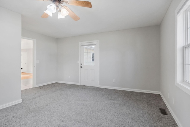 unfurnished room with carpet floors and ceiling fan