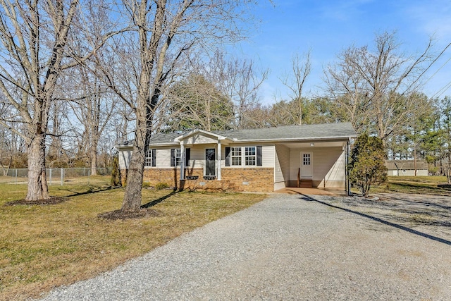 view of front facade featuring a front yard and a carport