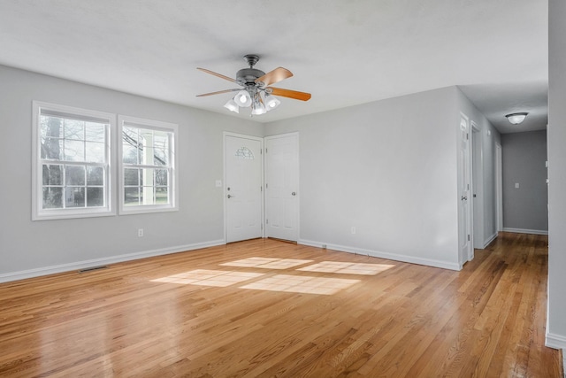 unfurnished room with ceiling fan and light wood-type flooring