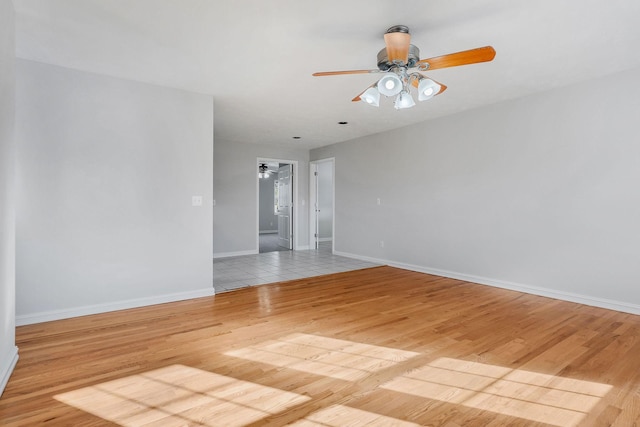 empty room with ceiling fan and light hardwood / wood-style floors