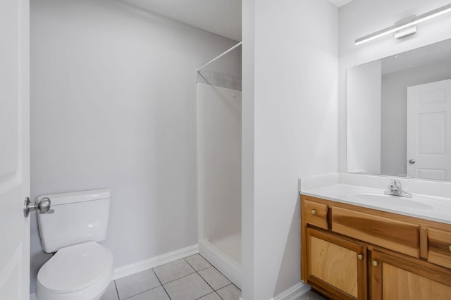 bathroom with toilet, a shower, tile patterned floors, and vanity