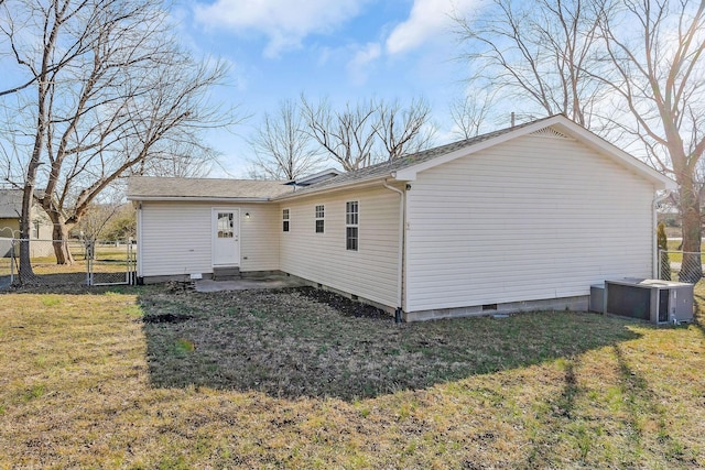 rear view of house with a yard and central AC unit