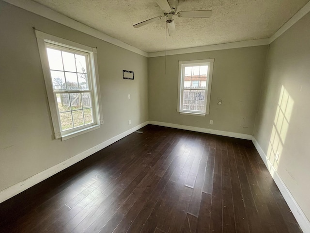 spare room with dark wood-type flooring, ceiling fan, and plenty of natural light