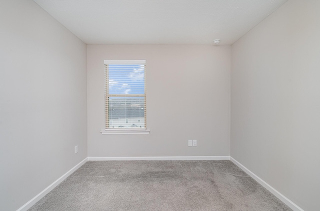 unfurnished room featuring carpet flooring