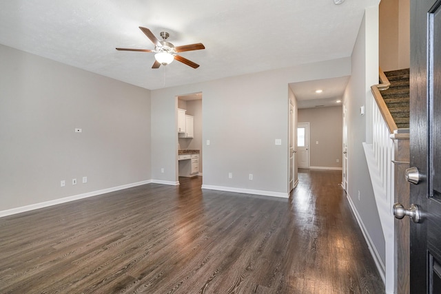 unfurnished living room with ceiling fan and dark hardwood / wood-style floors