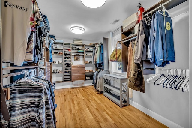 spacious closet with hardwood / wood-style flooring