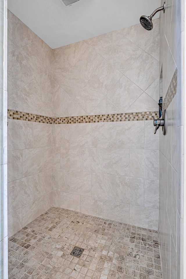 bathroom with a tile shower