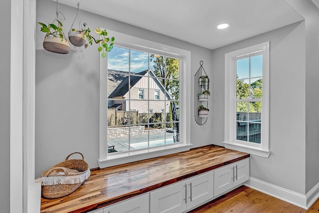 mudroom featuring light hardwood / wood-style floors, a wealth of natural light, and an inviting chandelier