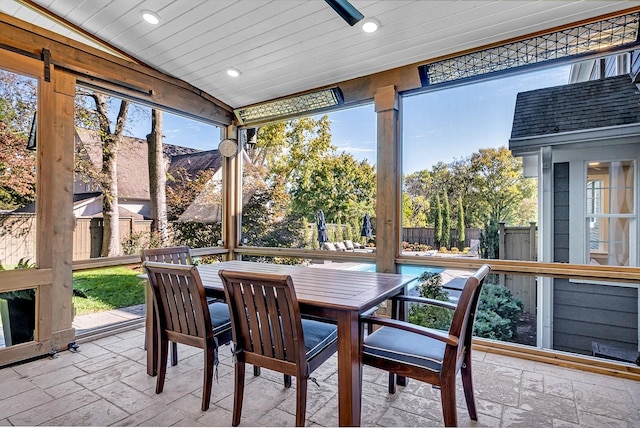 sunroom / solarium with wooden ceiling, lofted ceiling, and a barn door