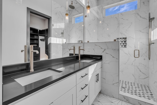 bathroom featuring tile patterned floors, a shower with door, and vanity