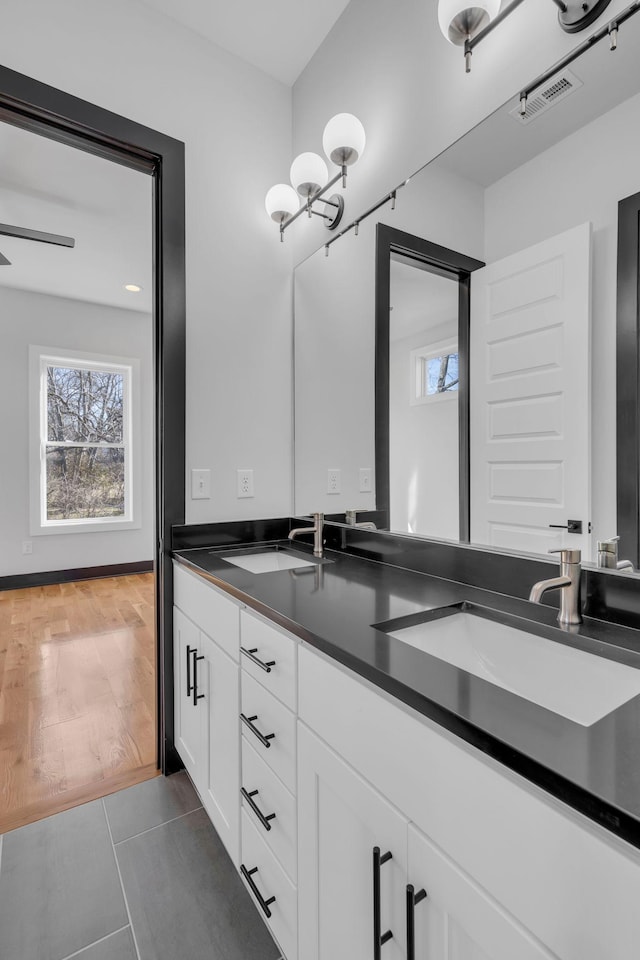 bathroom featuring tile patterned flooring, vanity, and a notable chandelier