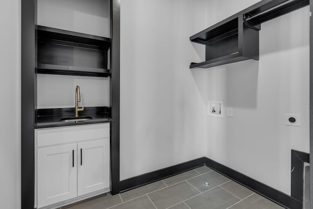 laundry area featuring cabinets, tile patterned floors, electric dryer hookup, sink, and hookup for a washing machine