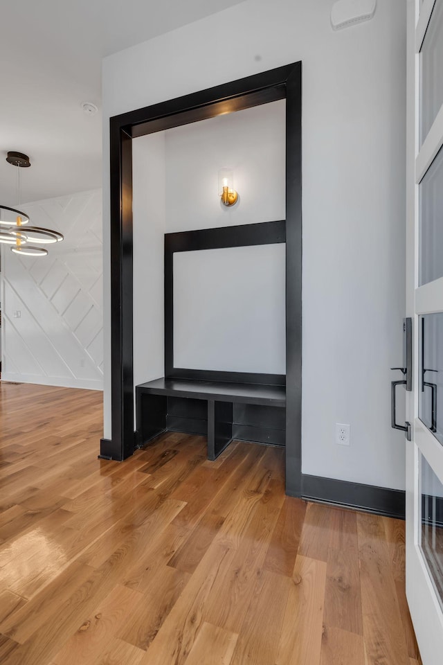 interior details with hardwood / wood-style floors and a notable chandelier