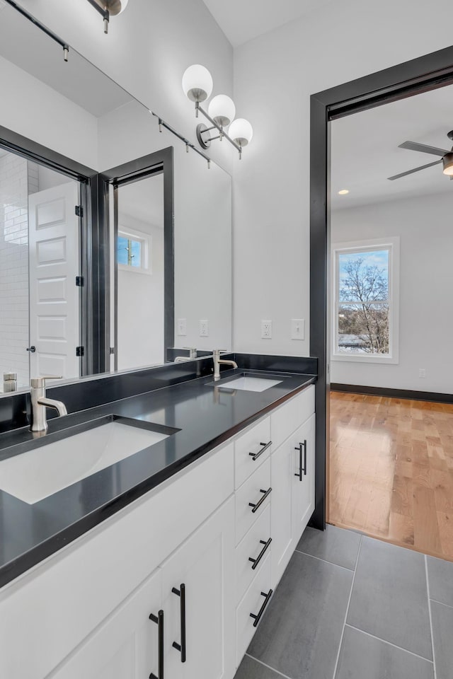 bathroom featuring ceiling fan, vanity, and tile patterned floors