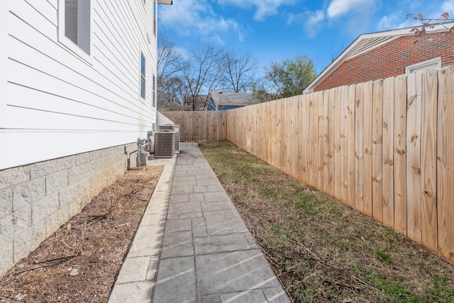 view of yard featuring central AC unit and a patio area