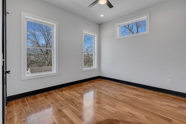 empty room featuring ceiling fan and light hardwood / wood-style floors