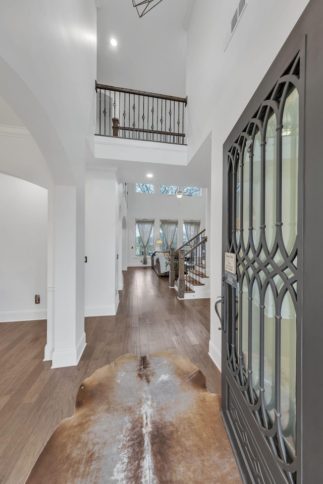 entrance foyer featuring dark hardwood / wood-style flooring and a high ceiling