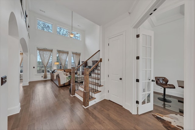 entrance foyer with crown molding and hardwood / wood-style floors