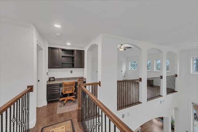 hall with ornamental molding and dark hardwood / wood-style flooring