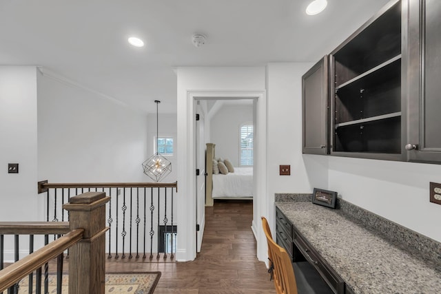 hall featuring dark wood-type flooring and crown molding