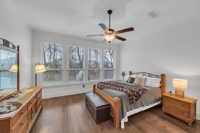 bedroom featuring ceiling fan, dark hardwood / wood-style flooring, and ornamental molding