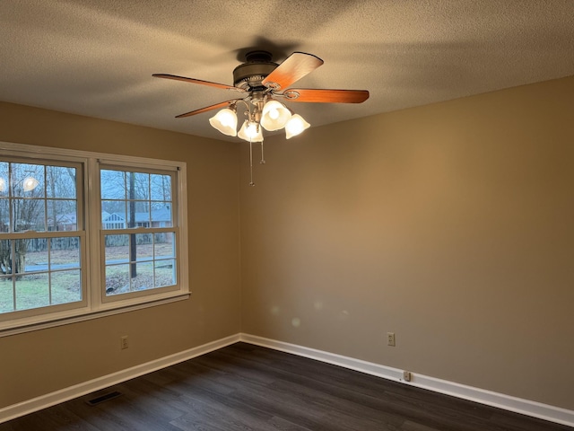 unfurnished room featuring dark hardwood / wood-style flooring, ceiling fan, and a textured ceiling