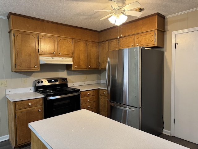 kitchen with ceiling fan, ornamental molding, a textured ceiling, and appliances with stainless steel finishes