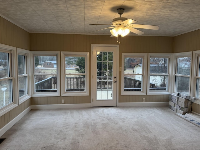 unfurnished sunroom with ceiling fan