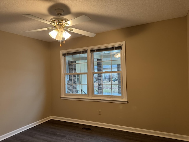 unfurnished room with ceiling fan, a textured ceiling, and dark hardwood / wood-style flooring