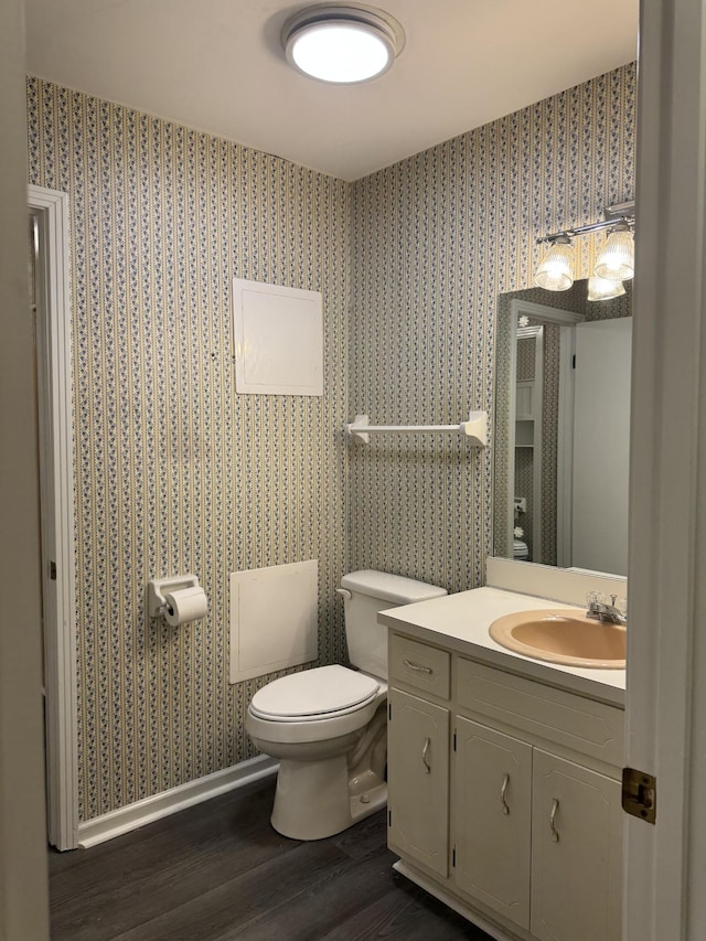 bathroom featuring wood-type flooring, vanity, and toilet