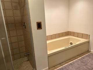 bathroom with tile patterned flooring and independent shower and bath