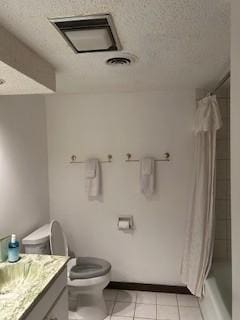 full bathroom featuring shower / tub combo with curtain, tile patterned flooring, vanity, toilet, and a textured ceiling