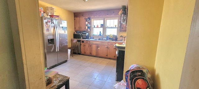 kitchen featuring stainless steel refrigerator with ice dispenser and light tile patterned floors