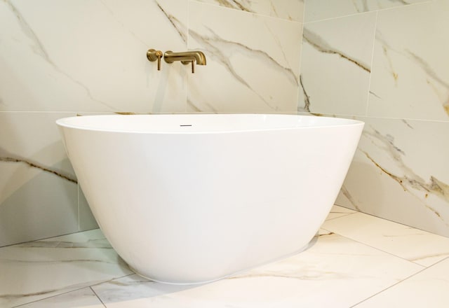 bathroom with a tub to relax in