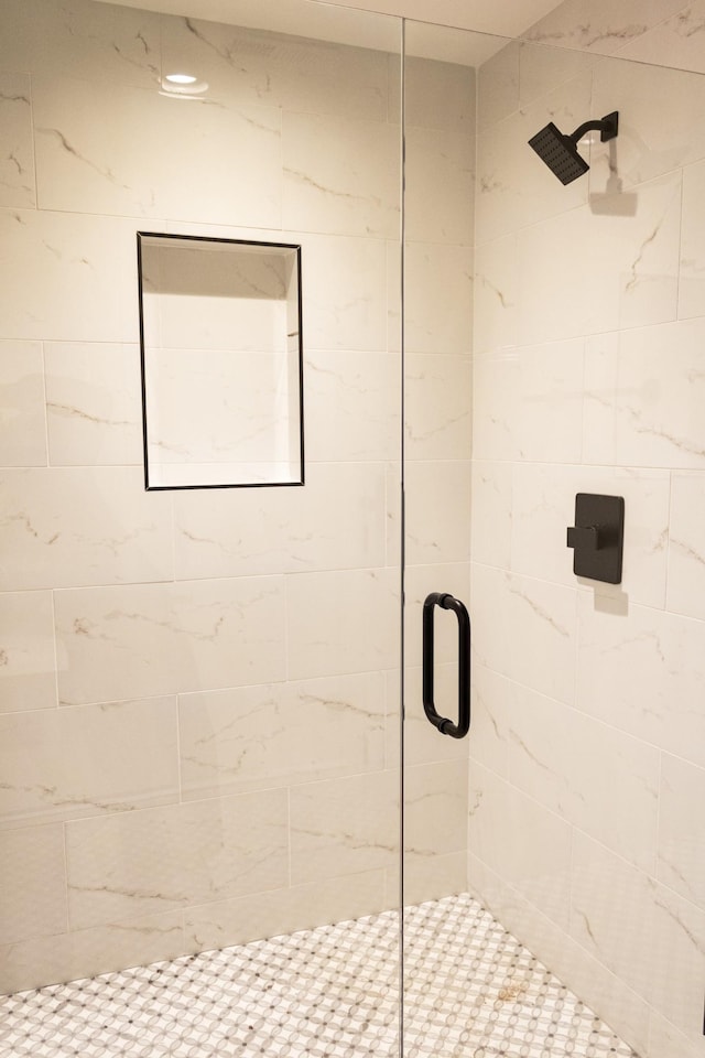 bathroom with a shower with door