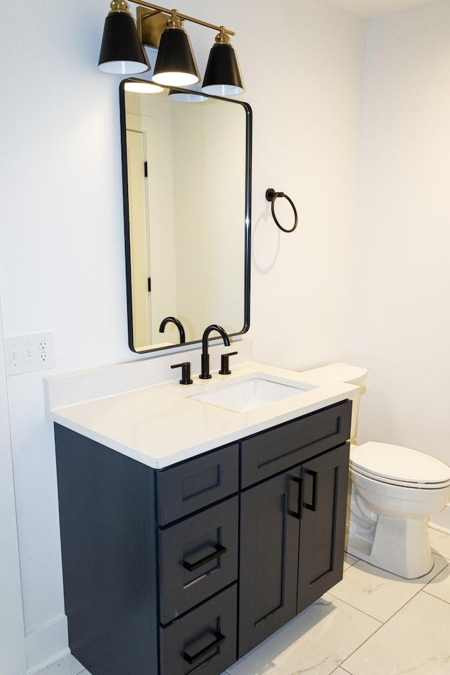 bathroom featuring vanity and toilet