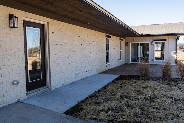 view of side of property with a patio area