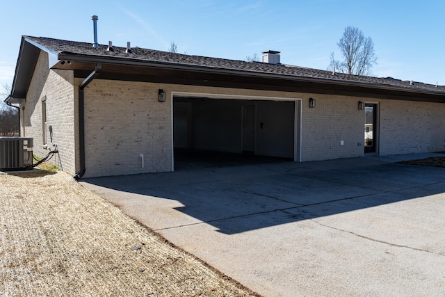 rear view of property with central AC