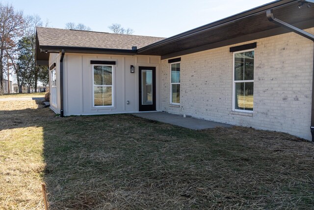 rear view of property featuring a yard