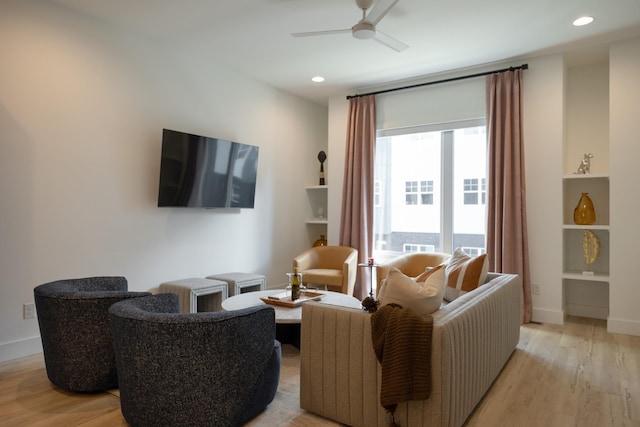 living room with ceiling fan and light hardwood / wood-style floors