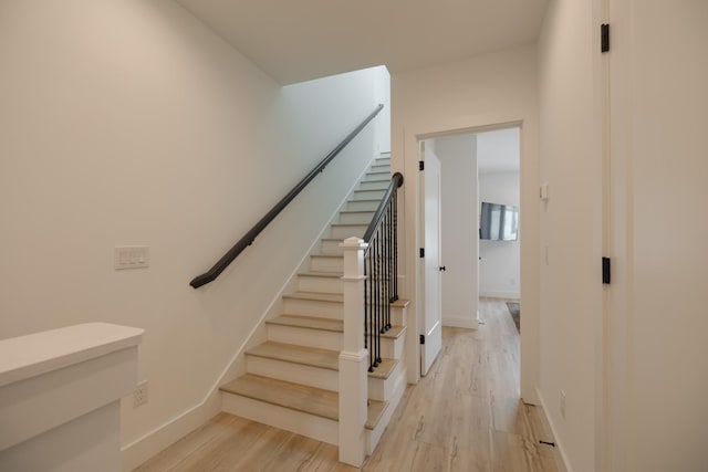 stairway featuring hardwood / wood-style floors