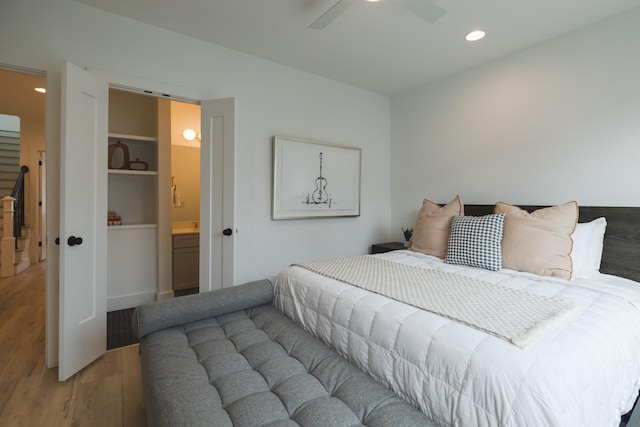 bedroom with ceiling fan, hardwood / wood-style flooring, and ensuite bathroom